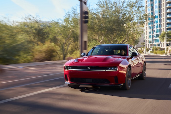 Red Dodge Charger Daytona driving on a road